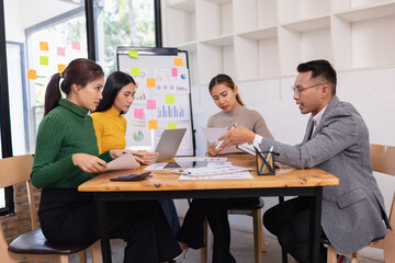 Group of business people working together with dashboard analysis and data management in conference...