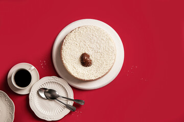 A delightful white cake with coffee sits on a vibrant