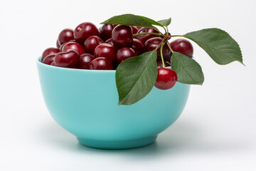 Ripe dark red cherries in blue bowl isolated on white background. Different angles. Place for design.  Close-up.