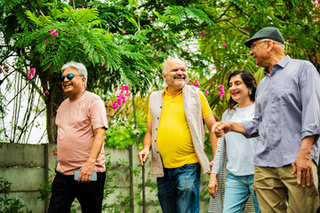 Elderly Indian friends reconnect in nature, enjoying laughter, memories,  lush green surroundings