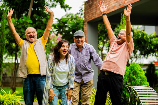 Seniors enjoying in laughter club outdoors with happy faces and positive energy in garden