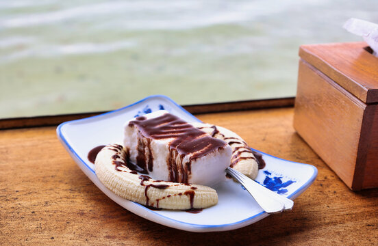 gourmet banana dessert with dark chocolate and coconat ice-cream