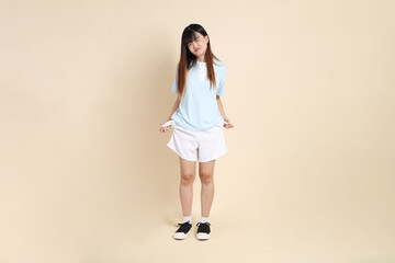 20s Asian Woman in Light Blue Shirt and White Shorts