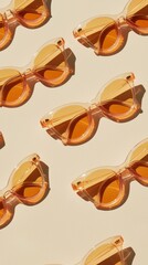 Stylish peach orange sunglasses artfully arranged on a smooth beige surface for a chic display
