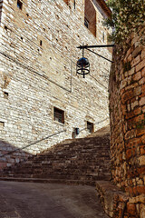 The charming medieval streets of Assisi in Umbria, Italy, with stone stairways and historic buildings