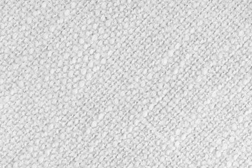 Close up, macro of white woven fabric with detailed texture and diagonal pattern. Textile, cloth, material, fashion, upholstery, or abstract design background.