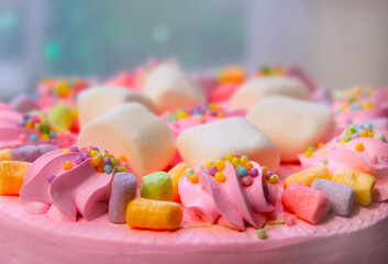 Arranged cream marshmallow cake for festive event. Sweet food, perfect for children's parties. Details of dessert table. Wedding accessories in a soft pink presentation. Decoration wedding party