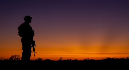 Fototapeta premium Silhouette of a Soldier at Sunset A Powerful Image Representing Military Service, Duty, and Sacrifice