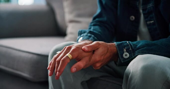 Anxiety, therapy and hands of man on sofa for fidgeting in stress, trauma or mental health session. Worry, nervous and male person stimming for panic attack, overthinking or fear at counseling clinic
