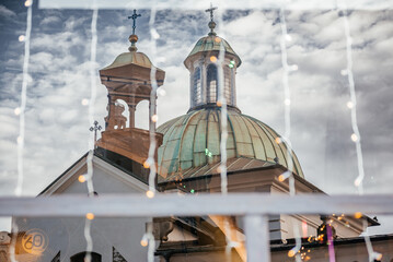 Christmas Lights and Church Reflections Through Window in Krakow Old Town