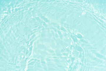 Blue water with ripples on the surface. Defocus blurred transparent blue colored clear calm water surface texture with splashes and bubbles. Water waves with shining pattern texture background.