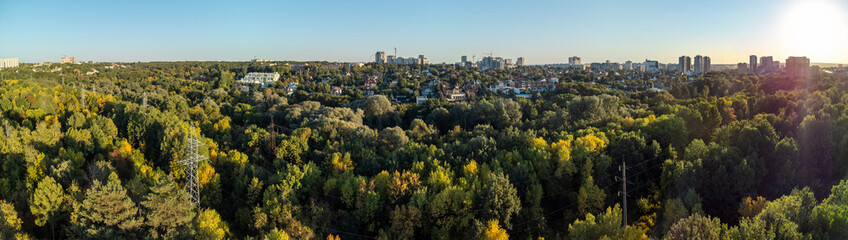 Sunny peaceful green park in the middle of Kharkiv city, high-angle aerial panorama