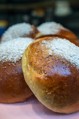 Krapfen or donut without a hole. Sweet donuts with powder sugar on dark industrial background. Food concept. Copy space.