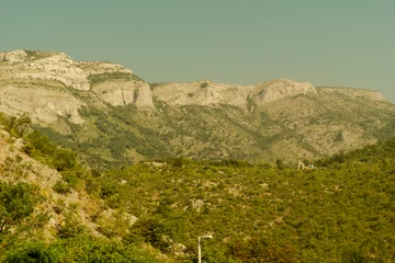 Fototapete Rund Mountain landscape with soft green hills and distant forested ridges © Світлана Чепурко
