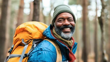 Outdoor enthusiast with beard and backpack, smiling for the camera.