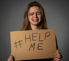 Crying Woman Holding Help Me Sign Against Grey Background