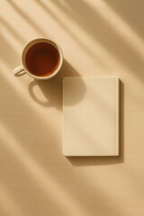 Beige notebook and tea cup on wooden table with sun shadows, minimalist setup. generative AI