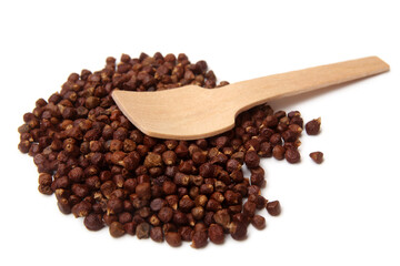 Grains of paradise (Aframomum melegueta) with wooden spoon
