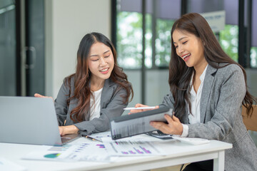 Two businesswoman hands or accountants working together on financial investment on calculator, calculating, analyzing business growth and marketing on graph.