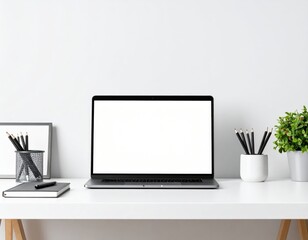 Fototapeta premium Minimalist workspace featuring laptop stationery and plant against a white wall