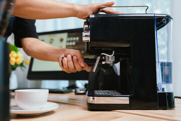 Barista pouring milk into cappuccino, creating latte art in cozy café setting, showcasing morning preparation, craftsmanship, and coffee culture indoors.