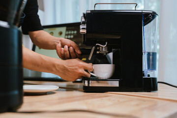 Barista pouring milk into cappuccino, creating latte art in cozy café setting, showcasing morning preparation, craftsmanship, and coffee culture indoors.