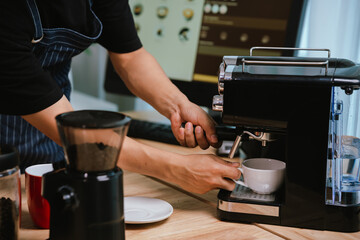 Barista pouring milk into cappuccino, creating latte art in cozy café setting, showcasing morning preparation, craftsmanship, and coffee culture indoors.