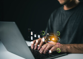 Man Using Laptop with Futuristic Technology Interface Displaying Data and Analytics in a Modern Business Environment at Night