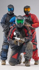 Studio portrait of paintball team in red and black uniforms holding markers in standing and kneeling pose against grey backdrop. Concept of sport and competition, tactical, team unity.
