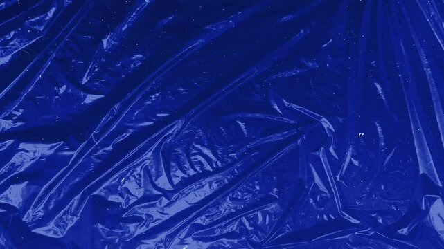 Abstract blue plastic texture featuring detailed creases and reflective surface for creative designs