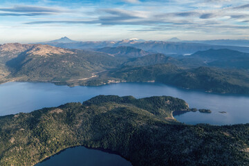 Aerial view of Villa Pehuenia with Lake Alumine and Andes Mountain Range in the distance. Neuquen, Patagonia, Argentina