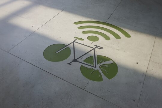Future mobility solutions provider of renewable energy sustainability concept. Bicycle symbol with Wi-Fi signal creatively designed on a concrete surface.