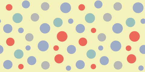 Colorful polka dots in red, light blue, and gray against a soft yellow background, creating a playful and vibrant pattern.
