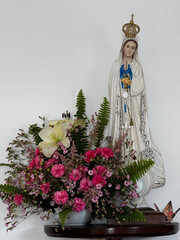 Mary, mother of jesus, sculpture in chapel along the St. James way in Arao, Portugal, with flowers