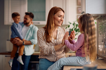 Happy mother and daughter having fun at home.