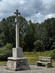 cross on the street in front of a garden on the camino de Santiago, St. James way, Caminho Portuguese