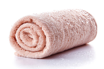 Rolled pink towel with water droplets on a white isolate background.