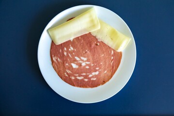 Close-up of a sliced bologna on a white plate