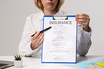 Person Holding Clipboard with Insurance Document Form