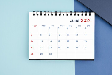 June 2026 monthly desk calendar for 2025 year on blue background.