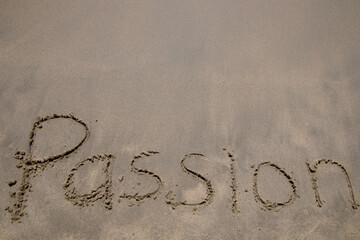 Words written in sand. The words PASSION written in the sand on the beach. 