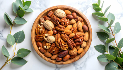 Assorted Nuts in Wooden Bowl with Eucalyptus Leaves