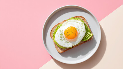 Clean modern scene of avocado toast with egg on white plate, placed on pastel pink and beige background, creating fresh and vibrant aesthetic