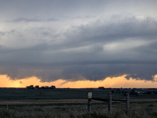 Funnel cloud over the horizon at sunset