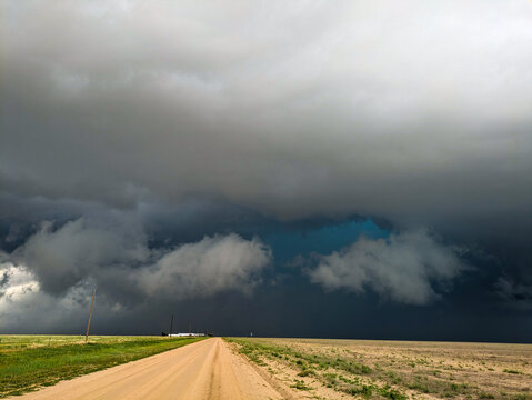 Turquoise Hail Core Peeking Out Behind a Shelf Cloud.