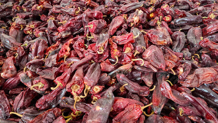 Red peppers in a drying shed. Smoked paprika factory.Salta, Argentina.Very close up of red peppers . Wallpaper. Space for copy. Background for brochures or natural organic culinary
