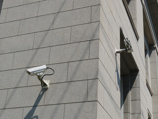 A surveillance camera is attached to the wall of the bank,
monitoring surrounding area for security.
