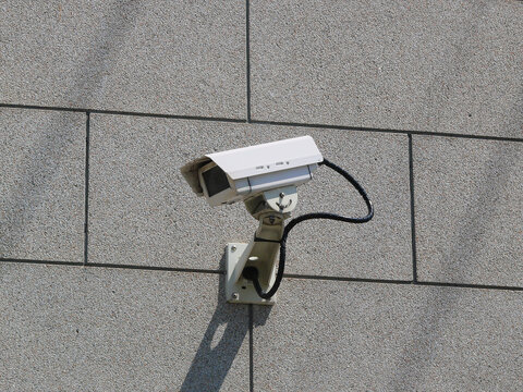 A surveillance camera is attached to the wall of the bank,
monitoring surrounding area for security.