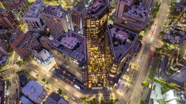 Santiago, Chile &ndash; October 16, 2024: Drone approaches MUT building at twilight, capturing vibrant city lights and urban skyline from above in the financial district of Las Condes.