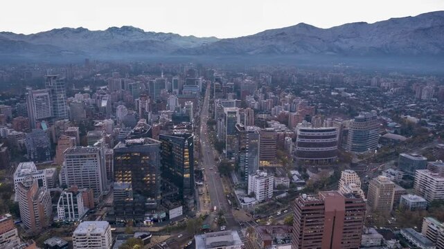 Santiago, Chile &ndash; May 8, 2025: Drone moves laterally at sunrise, capturing MUT building and snowy Andes in the background. Early morning light enhances the city's architecture and skyline.